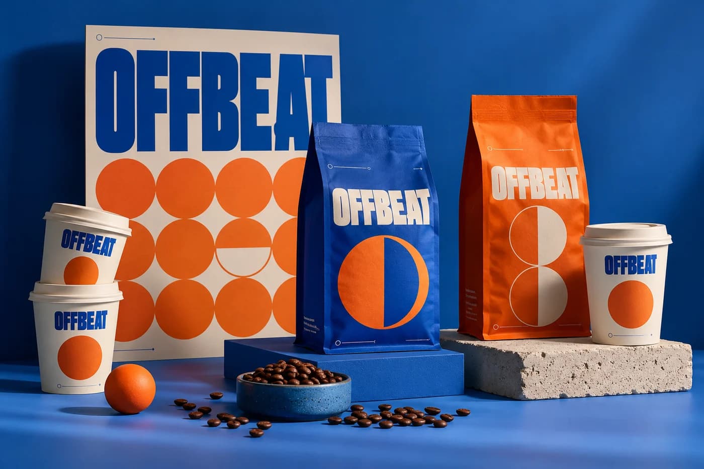 Fictional OFFBEAT coffee bags and takeaway cups in cobalt blue and tangerine